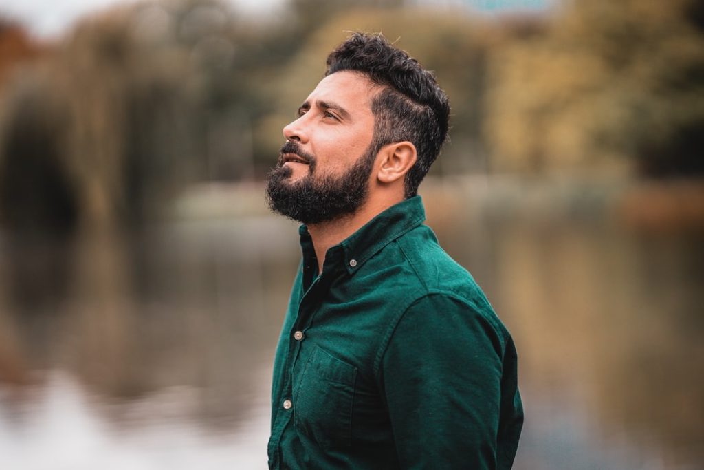 Confident Man looking upward, lake in the background