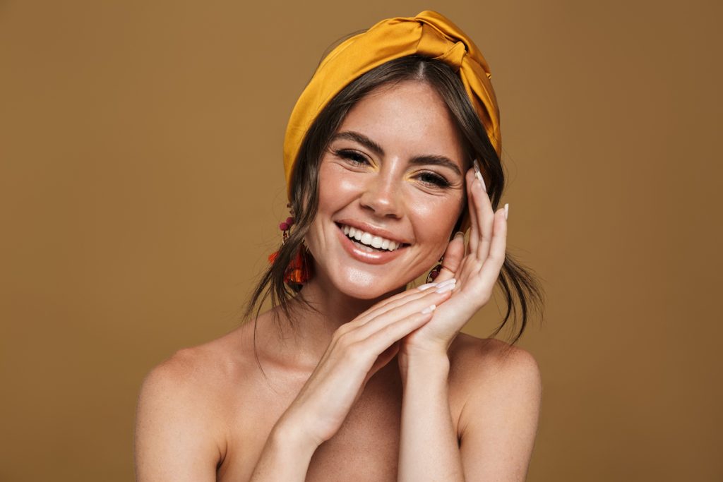 Woman looking at viewer, with yellow bandana