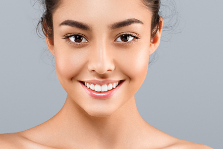 Young woman with clear skin smiling at the camera