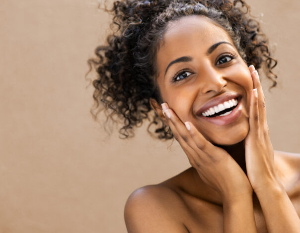 Beautiful young woman smiling after fantastic face treatment . 