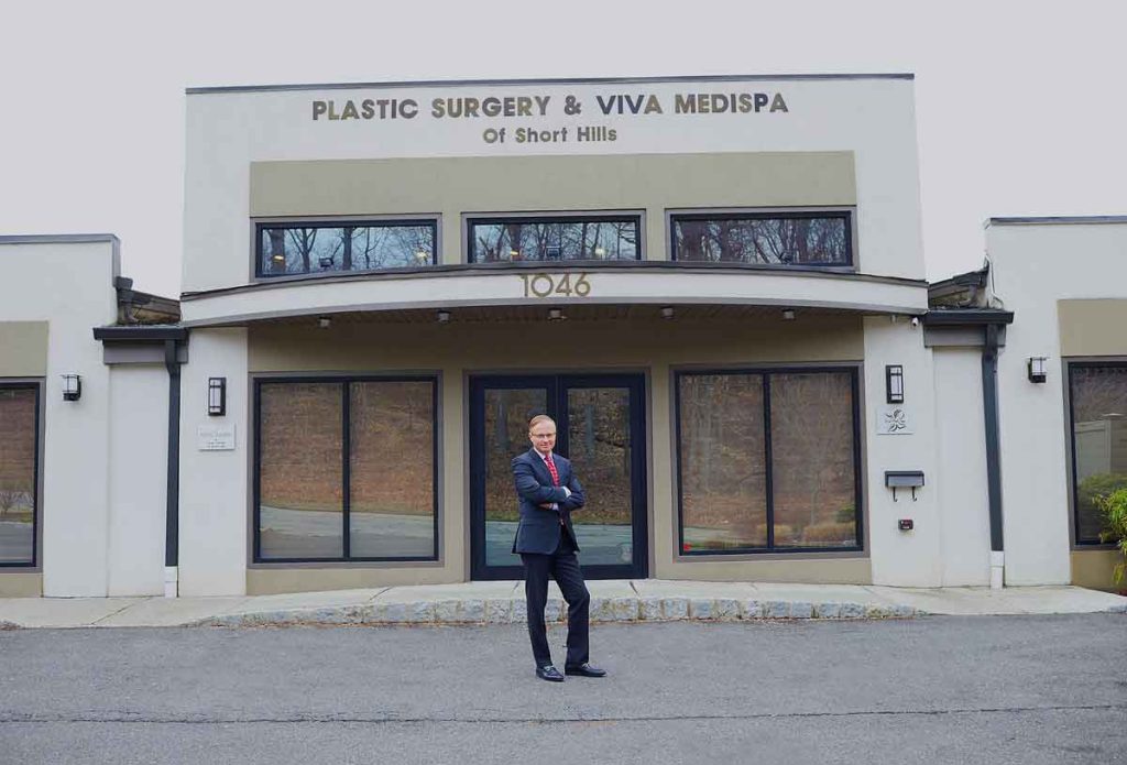 Dr Ovchisnky standing in front of his practice